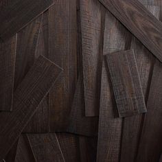 dark wood planks are stacked together on the wall