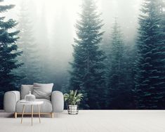 a couch sitting in front of a forest wall mural