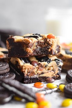 chocolate chip cookie bars stacked on top of each other with halloween candy in the background