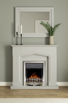 a white fireplace with a mirror above it and candles on the mantle next to it