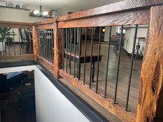 the inside of a building with wooden railings and metal balconies on it