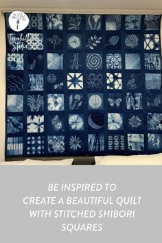 a blue and white quilt hanging on a wall with the words be inspired to create a beautiful quilt with stitched shibori squares