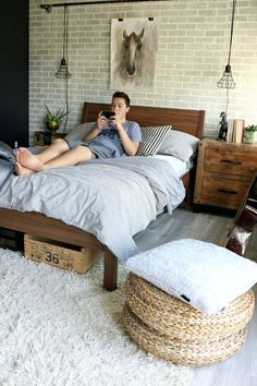 a man laying on top of a bed in a bedroom