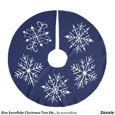 a blue and white christmas tree skirt with snowflakes on it