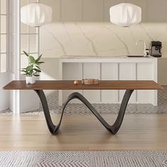 a wooden table sitting on top of a hard wood floor next to a white wall