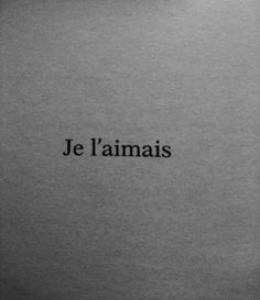 the words je l'amais are written in black ink on a gray background