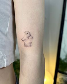 a small bunny tattoo on the arm