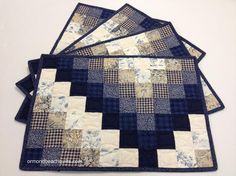 four quilted placemats on top of each other