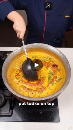 a person stirring food in a pan on top of a stove