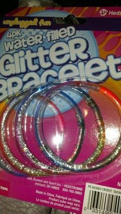 three pieces of glitter bracelets on top of each other in front of a package