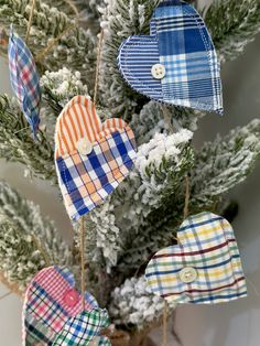 three heart shaped ornaments hanging from a christmas tree