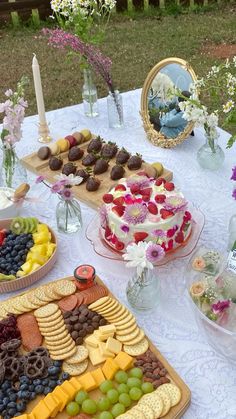 a table topped with lots of different types of foods and desserts on top of plates