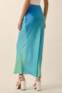 Ombre satin maxi skirt. High waist. Bias cut. Invisible zipper side closure. Straight silhouette. Ankle length. Relaxed fit. 100% Polyester. Imported. Designed in LA. Model wears size S. Spring Full-length Satin Skirt, Spring Bias Cut Relaxed Maxi Skirt, Spring Relaxed Bias Cut Maxi Skirt, Spring Relaxed Fit Bias Cut Maxi Skirt, Summer Satin Bias Cut Skirt, Summer Satin Skirt With Bias Cut, Flowy Wide Leg Skirt With Bias Cut, Summer Silk Bottoms With Bias Cut, Blue Maxi Length Party Bottoms