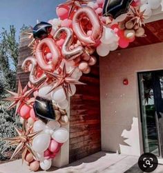 the balloon arch is decorated with stars and balloons