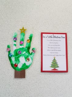 a hand made out of paper next to a christmas card