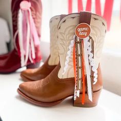 The perfect gameday accessory is here! Add a touch of pride and style with your gameday Boot Button. Wear them solo or add some ribbon for an extra touch of flare! Pair your boot buttons with our Vegan Inlay boots to complete your gameday look! Set includes two (2) Game Day Buttons and velcro strip attachments Ribbon not included Cowgirl Boots With Ribbon, Ribbon On Boots, Cowboy Boots With Ribbon, Game Day Boots Ribbon, Game Day Cowboy Boots, How To Make Boots, Game Day Buttons, Diy Buttons, Cowgirl Boots