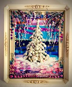 a christmas tree made out of seashells and pearls in a frame on the wall