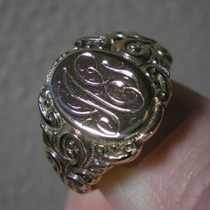 Such a beautiful ring for they guys but could be sized down for the ladies, within reason. This ring has fabulous scroll detailing on the shoulders. The oval face area is approx. 5/8 inches long and under 1/2 inch wide. Marks are the back 10 k and tested as such. Ring is heavy at 8.8 grams and approx. a size 13. This ring has been size up in the past. You can feel a slight ripple in the band in back as well as it being a bit thinner. Not an issue but an observation. The initials on the face look Ag Monogram, Signet Rings, Oval Face, Oval Faces, Gift For Husband, Beautiful Ring, Signet Ring, Gifts For Husband, Class Ring