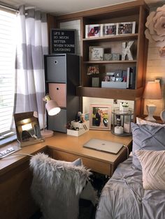 a bedroom with a bed, desk and computer