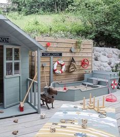 there is a dog that is standing in front of a shed with its door open