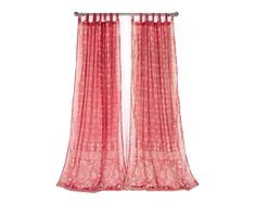 a red curtain hanging on the side of a window with curtains pulled back to reveal an intricate lace pattern