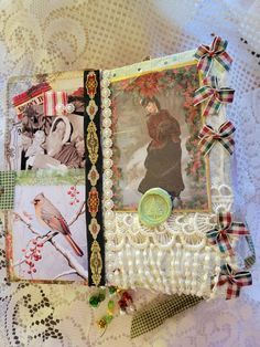 an altered photo album is sitting on a lace tablecloth