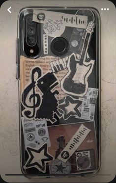 a cell phone case with various stickers and music notes on the back, including an electric guitar