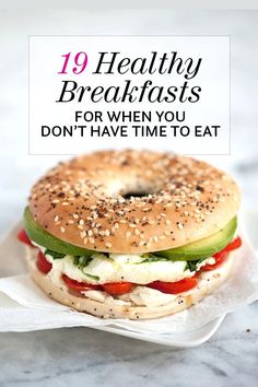 a bagel sandwich with tomatoes, cucumber and feta cheese on it