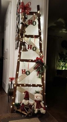 a ladder decorated with christmas lights and teddy bears