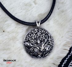 Introducing our exquisite Silver Floral Medallion Pendant, a true testament to timeless beauty and unparalleled craftsmanship. Meticulously crafted using the die-striking method, this pendant showcases intricate floral motifs inspired by a vintage die carved at the turn of the last century. Made from high-quality silver, this pendant exudes elegance and sophistication. The die-striking technique ensures a flawless and durable piece that will last for generations to come. Each detail of the flora Antique Silver Flower Pendant Necklace With Engravings, Antique Silver Engraved Flower Pendant Necklace, Antique Silver Engraved Flower Pendant Jewelry, Antique Engraved Flower Pendant Necklace, Luxury Engraved Flower Pendant Jewelry, Luxury Etched Pendant Jewelry, Flower Statement Necklace, Cord Necklace, Floral Motifs