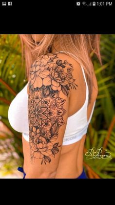 a woman's arm with flowers on it, and the back of her body