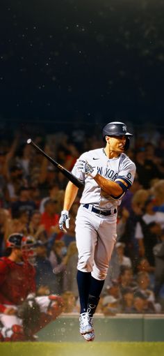 a baseball player is running in the air with his bat out and people watching from the stands