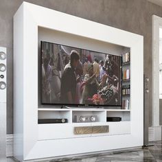 a flat screen tv sitting on top of a white entertainment center in a living room