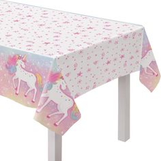 a pink table cloth with unicorns on it