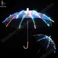 two umbrellas with lights on them in the dark, one has an open umbrella