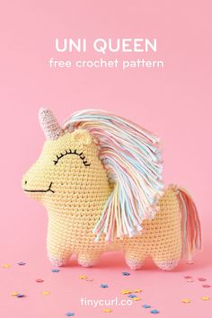 a crocheted stuffed toy unicorn on a pink background with sprinkles