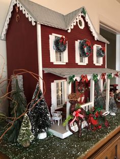 a red house with christmas decorations on the roof