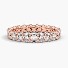 a rose gold and white diamond ring with rows of round diamonds on the side, set in