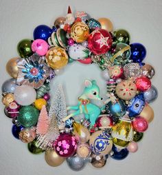 a christmas ornament wreath with ornaments around it