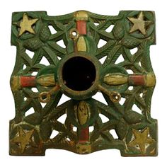 an ornate green and gold object with stars on it