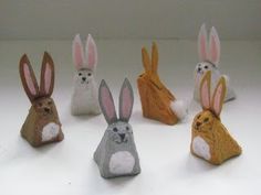 five small wooden rabbits sitting next to each other