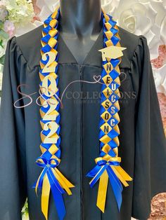 a graduation gown with blue, yellow and white ribbons