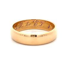 This Victorian 18 karat yellow gold wedding band captures the essence of the era with its rounded flat edge, offering a unique and elegant profile. The inside of the ring features the original wedding date engraving, adding a sentimental touch that connects to its rich history. Perfect for those who appreciate vintage beauty and historical significance, this wedding band is a testament to enduring love and tradition Timeless Polished Promise Band, Timeless Promise Band With Polished Finish, Classic Promise Ring With Thick Band, Timeless Promise Bands, Heirloom Engraved Round Band Rings, Heirloom Style Round Promise Band, Classic Promise Ring With Decorative Band, Timeless Engraved Round Band Promise Ring, Timeless Engraved Promise Ring