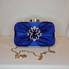 Womens royal blue cobalt satin finish evening clutch bag with ruched crystal rhinestone detailed front, gold crystal brooch embellishment and top closing clasp Can be used with or without long shoulder chain (included) size approx- H 12cm x W 20cm Free Royal Mail delivery is an estimated 3-5 days but this can occasionally be slightly longer which solely on the Royal Mail side. We do offer guaranteed next day delivery but please contact us prior to ordering as this would incur a small upgraded shipping charge. We also offer WORLDWIDE shipping - please contact us for more info 💕🌍 Blue Rhinestone Evening Bag For Party, Blue Rhinestone Evening Bag For Weddings, Blue Rhinestone Clutch For Party, Blue Embellished Evening Bag For Formal Occasions, Glamorous Blue Evening Bag For Party, Royal Blue Rectangular Evening Bag, Formal Blue Embellished Evening Bag, Blue Evening Clutch With Rhinestones, Elegant Blue Evening Bag With Rhinestones