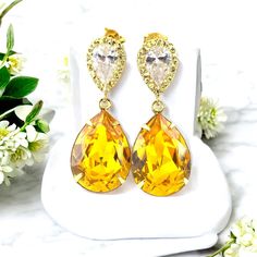 These timeless Swarovski Yellow Earrings have a Victorian touch of elegance and romance! A bright, happy and super sparkly jewelry that will light up your day!  I made the gorgeous Earrings with: - the Genuine and unique 18x13mm Swarovski Sunflower Yellow teardrop pear shaped fancy stones, set in gold plated settings - Hypoallergenic and tarnish resistant, 16k gold plated pear shaped ear posts with AAA cubic zirconia stones - these are approx 1 1/4" from top of the ear posts to bottom of the sto Classic Yellow Teardrop Earrings, Pear-shaped Crystal Earrings As A Gift, Pear-shaped Crystal Earrings Gift, Gold Cubic Zirconia Teardrop Earrings As Gift, Elegant Yellow Dangle Clip-on Earrings, Yellow Gold Cubic Zirconia Teardrop Earrings Gift, Yellow Clip-on Earrings For Anniversary, Yellow Teardrop Earrings For Wedding, Sparkling Stone Pear Earrings As Gift