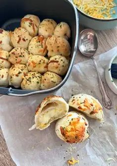 some food that is in a pan and on a table with utensils next to it