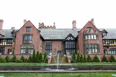 a large brick building with a fountain in front of it