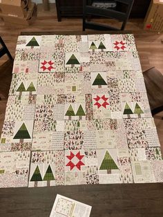 a quilted table topper with christmas trees on it