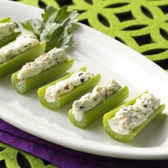 celery sticks with cream cheese and herbs on them