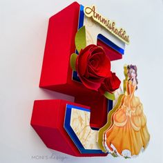 the letter e is made out of paper and has a rose on it